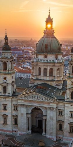 Budapest, Hungary - The rising sun shining through the tower of the beautiful St.Stephen's Basilica (Szent Istvan Bazilika) at sunrise on an aerial shot